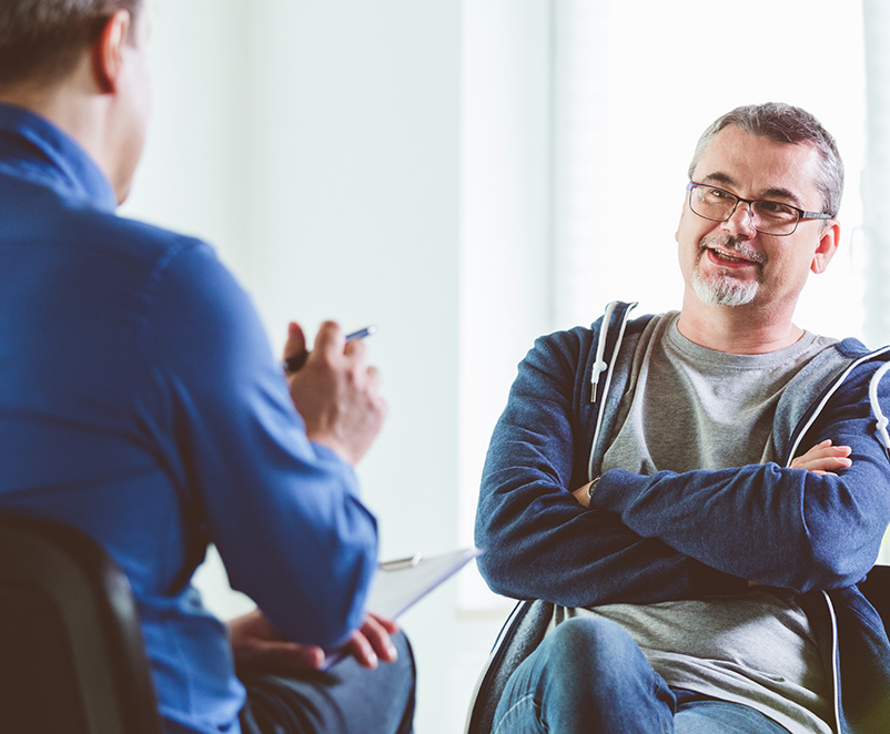Photograph of of 2 males having a conversation